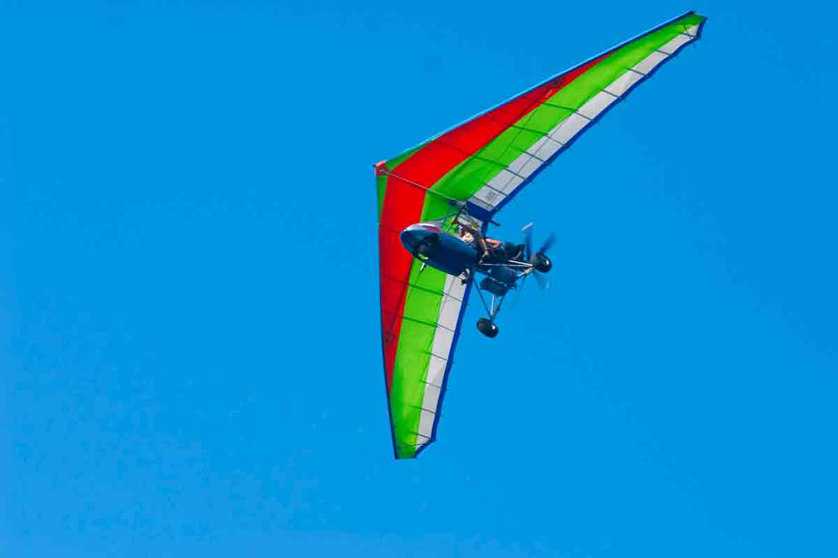 Ultralight Aircraft - soaring a motorized hang-glider on a background blue sky